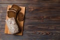 Freshly baked bread slices on cutting board against white wooden background. top view Sliced bread Royalty Free Stock Photo