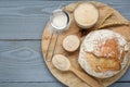 Freshly baked bread, sourdough and flour on grey wooden table, top view. Space for text Royalty Free Stock Photo