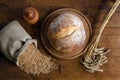 Freshly baked bread, spikelets and grain of wheat