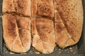 Freshly baked bread from wheat and whole meal flour with yeast on a baking tray, high angel view from above, selected focus