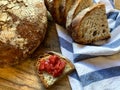 Freshly Baked Bread on Wooden Board and a slice with Homemade Strawberry Jam Royalty Free Stock Photo