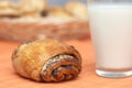 Freshly baked bun with poppyseeds and milk Royalty Free Stock Photo