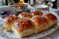 Freshly baked buns with sesame seeds on a decorative plate Royalty Free Stock Photo