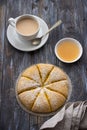 Freshly baked carrot scones with honey and cup of tea with milk on wooden background Royalty Free Stock Photo