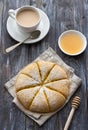 Freshly baked carrot scones with honey and cup of tea with milk on wooden background Royalty Free Stock Photo