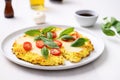 freshly baked cauliflower pizza with basil leaves on a white plate