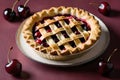 A freshly baked cherry pie on a cream plate, surrounded by juicy red cherries against a deep red background