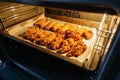 Freshly baked chicken fillet on a baking sheet in an electric oven. Cooking chicken nuggets. Series Royalty Free Stock Photo