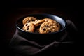 Freshly Baked Chocolate Chip Cookies in a Dark Bowl Royalty Free Stock Photo