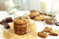 Freshly baked chocolate chip cookies with glass of milk on rustic wooden table. Royalty Free Stock Photo