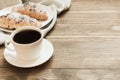 Freshly baked chocolate croissants and cup of black coffee on wooden cutting board. Close up. Copy space. Royalty Free Stock Photo