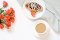 Freshly baked chocolate croissants and cup of coffee on white table. Top view. Female breakfast. Copy space. Royalty Free Stock Photo