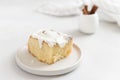 Freshly baked cinnabon or cinnamon roll with creamcheese frosting on gray plate white background. Side view, close up. Bakery menu Royalty Free Stock Photo