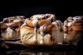 Freshly baked cinnabon rolls with sweet glaze on a black background. Generated AI Royalty Free Stock Photo