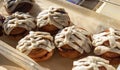 Freshly baked cinnamon buns with fancy white icing are on display in a tabletop case