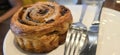 freshly baked Cinnamon rolls or cinnamon bun with raisins and vanilla also icing sugar ridiculously good Royalty Free Stock Photo