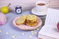 Freshly baked coconut cookies with white chocolate on a beautiful plate, on a gray wooden background, surrounded by a cup of tea, Royalty Free Stock Photo