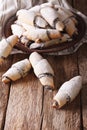 Freshly baked crescent with poppy stuffing close-up. vertical