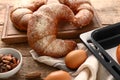 Freshly baked crescent rolls on wooden table