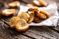 Freshly baked crispy bake rolls with goldish colour served in the paper on a rustic wooden desk Royalty Free Stock Photo