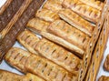 Freshly baked crispy bread buns on a counter or shelf in a store, close-up. Bakery products are sold in the market. Fresh bakery. Royalty Free Stock Photo