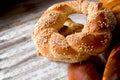 Freshly baked crispy pretzel with sesame on rustic table Royalty Free Stock Photo