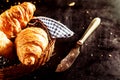 Freshly Baked Croissant and Cutting Knife on Table Royalty Free Stock Photo