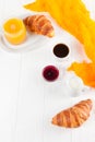Freshly baked croissant orange juice, jam, cup of black coffee on white wooden background. French breakfast. Fresh pastries for mo Royalty Free Stock Photo