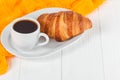 Freshly baked croissant orange juice, jam, cup of black coffee on white wooden background. French breakfast. Fresh pastries for mo Royalty Free Stock Photo