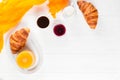 Freshly baked croissant orange juice, jam, cup of black coffee on white wooden background. French breakfast. Fresh pastries for mo Royalty Free Stock Photo