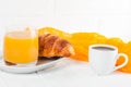 Freshly baked croissant orange juice, jam, cup of black coffee on white wooden background. French breakfast. Fresh pastries for mo Royalty Free Stock Photo