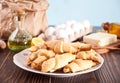 Freshly baked croissant on the plate with ingredients and kitchen utencil on the wooden table. Royalty Free Stock Photo