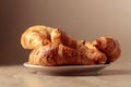 Freshly baked croissants on a beige ceramic table