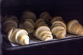 Freshly baked croissants with chocolate on a baking tray in the oven Royalty Free Stock Photo