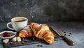 Freshly baked croissants, cup of morning coffee and bowl with jam. Tasty and sweet dessert Royalty Free Stock Photo