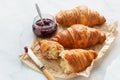 Freshly baked croissants with jam and butter for breakfast Royalty Free Stock Photo