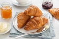 Freshly baked croissants with jam and butter for breakfast Royalty Free Stock Photo