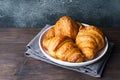 Freshly baked croissants on a plate, dark background, copy space Royalty Free Stock Photo