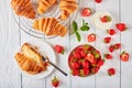 Freshly baked croissants with ripe berries Royalty Free Stock Photo