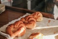 Freshly baked croissants shiny in the rays of the morning sun on wooden tray. Royalty Free Stock Photo