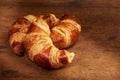 Freshly baked croissants on wooden cutting board, close-up Royalty Free Stock Photo