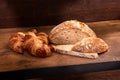 Freshly baked croissants on wooden cutting board, close-up Royalty Free Stock Photo