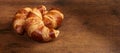 Freshly baked croissants on wooden cutting board, close-up Royalty Free Stock Photo