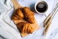 Freshly baked croissants on wooden cutting board. Royalty Free Stock Photo