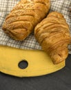 Freshly baked croissants on wooden cutting board, top view. Royalty Free Stock Photo