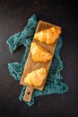 Freshly baked croissants on wooden cutting board, top view Royalty Free Stock Photo