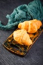 Freshly baked croissants on wooden cutting board, top view Royalty Free Stock Photo