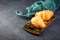 Freshly baked croissants on wooden cutting board, top view Royalty Free Stock Photo