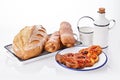 Freshly baked crusty homemade butter rolls and baked bread isolated on white background, traditional Bulgarian breakfast