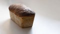 Freshly baked crusty loaf of homemade premium rye and wheat flour bread on white table. Contains gluten, Vegetarian food